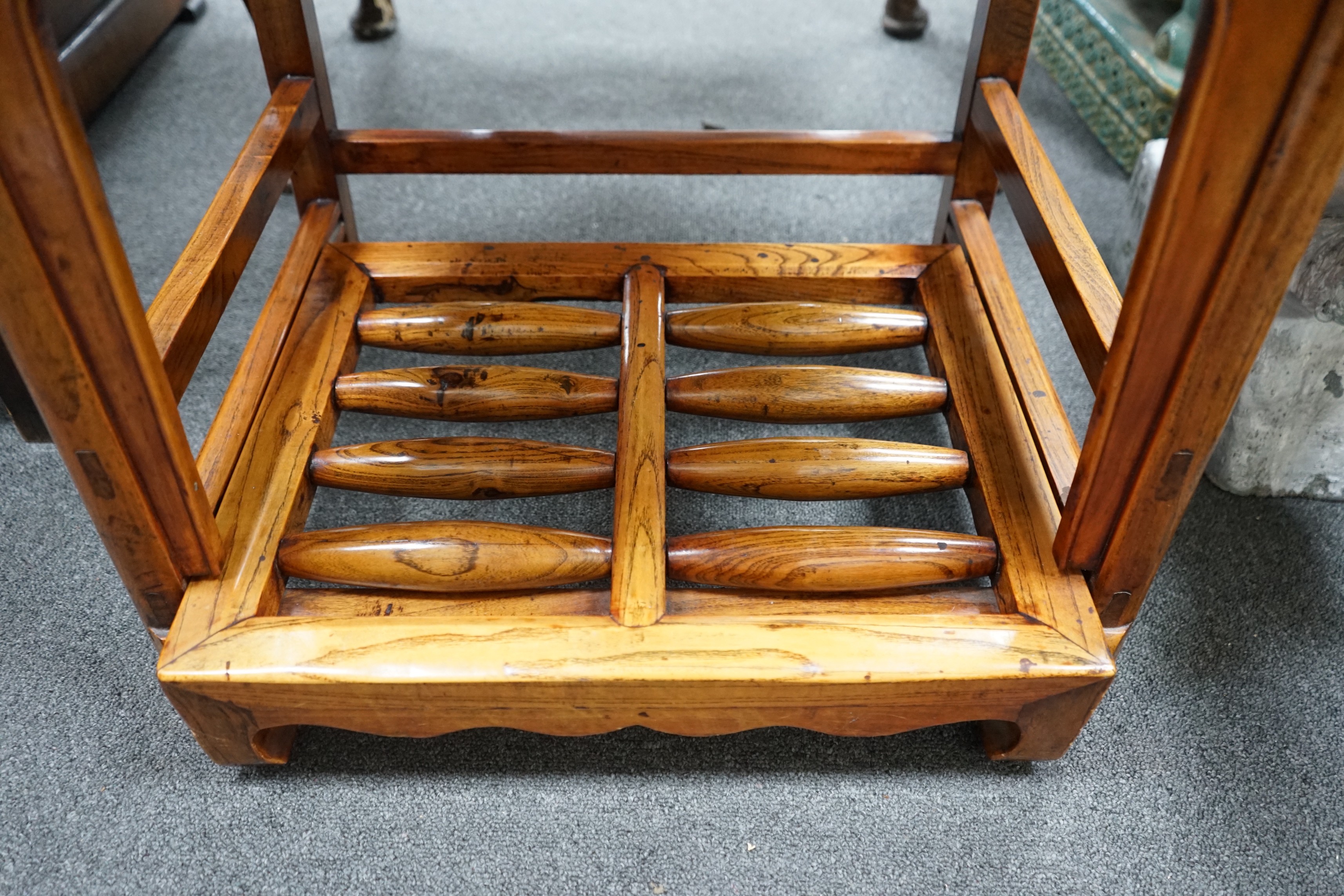 A pair of Chinese elm armchairs with roller footrests, width 57cm, depth 53cm, height 89cm